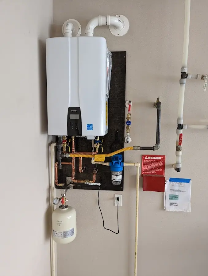 Professional plumber installing copper piping in a Royalton home